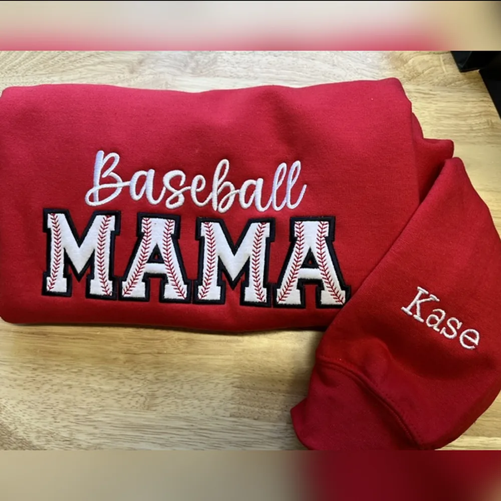 Red sweatshirt with Baseball in white script over MAMA in baseball-stitch letters, and Kase on the sleeve.