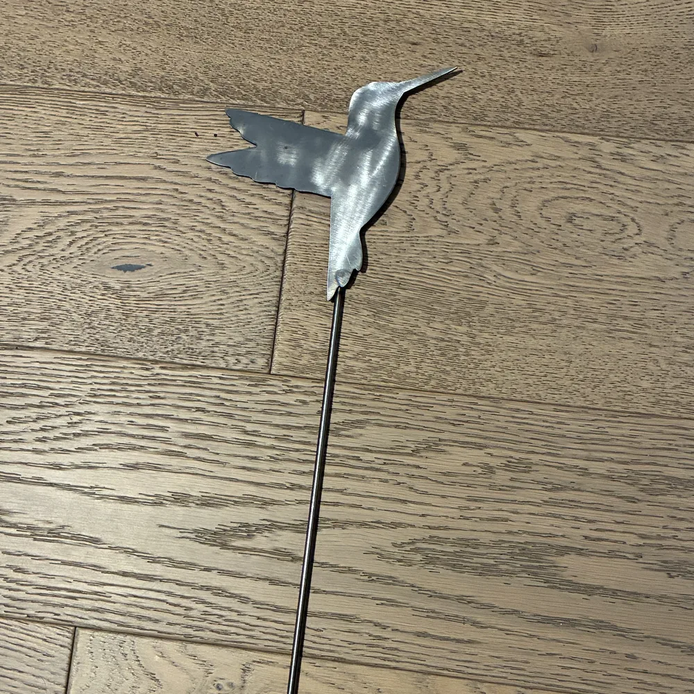 Steel yard stake shaped like a hummingbird.