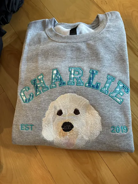 Gray sweatshirt embroidered with CHARLIE EST 2019 and a white doodle dog portrait