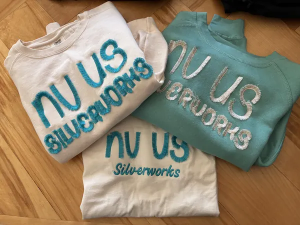 Three NV US Silverworks sweatshirts with frayed chenille-style letters